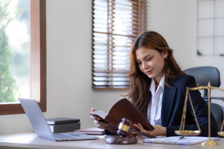Beautiful asian woman lawyer working and gavel, tablet, laptop in front, Advice justice and law