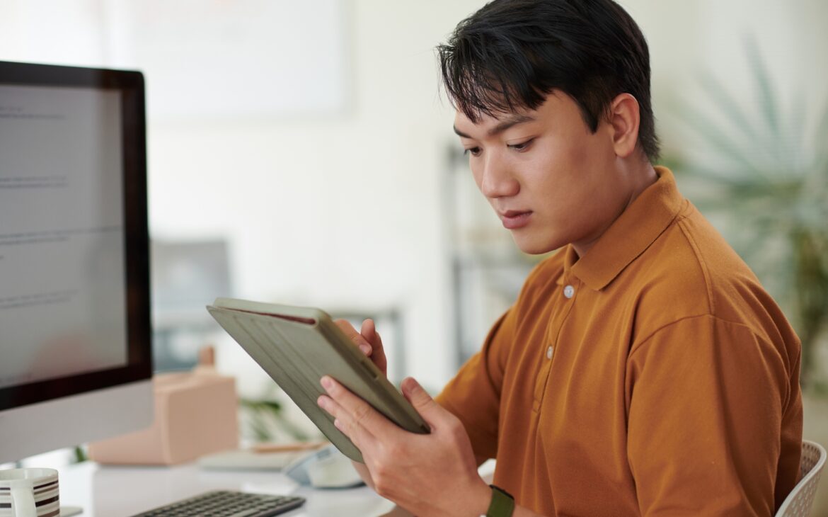 Developer Reading Documentation on Tablet