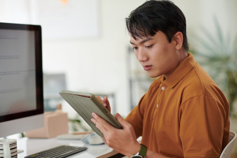 Developer Reading Documentation on Tablet