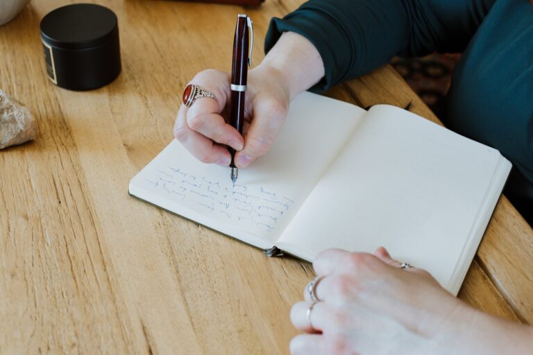 Woman's Hand Writing in a Journal / Diary