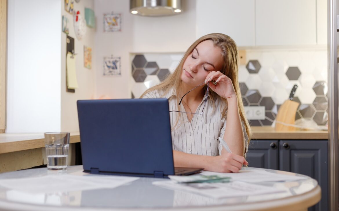 Fatigued businesswoman taking off glasses tired of computer work