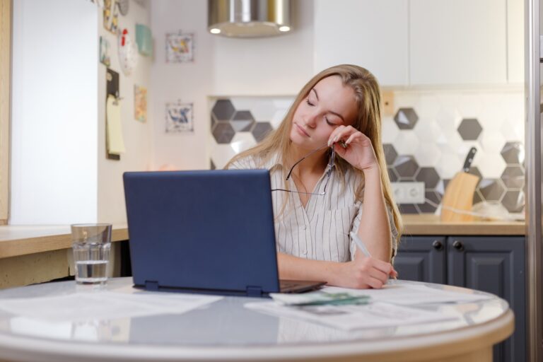 Fatigued businesswoman taking off glasses tired of computer work