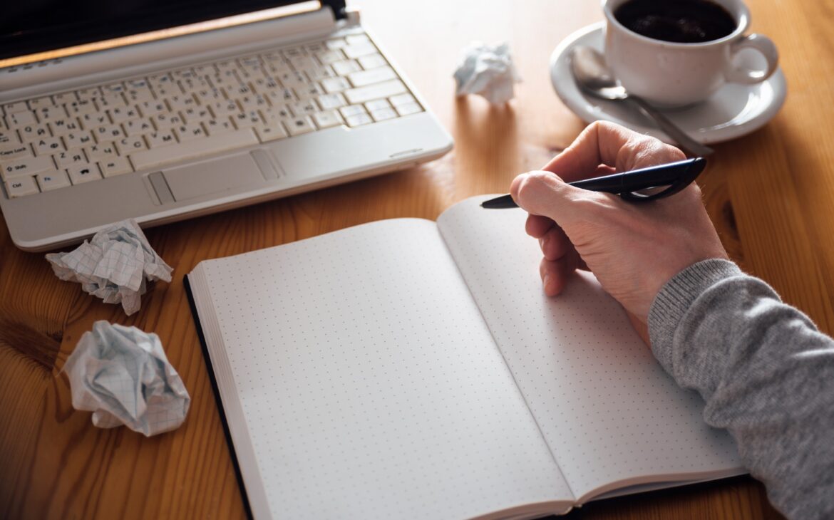 Man hand writing in planner