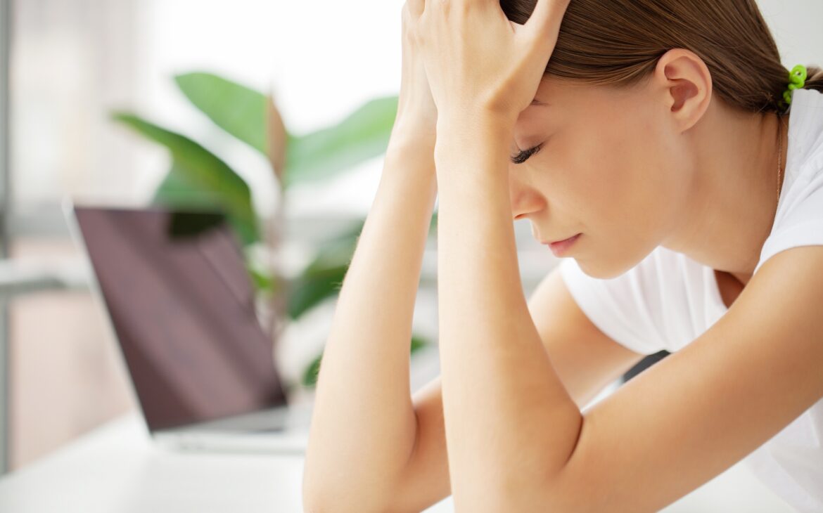 Stressed Business Woman Holding Her Head With Hand In