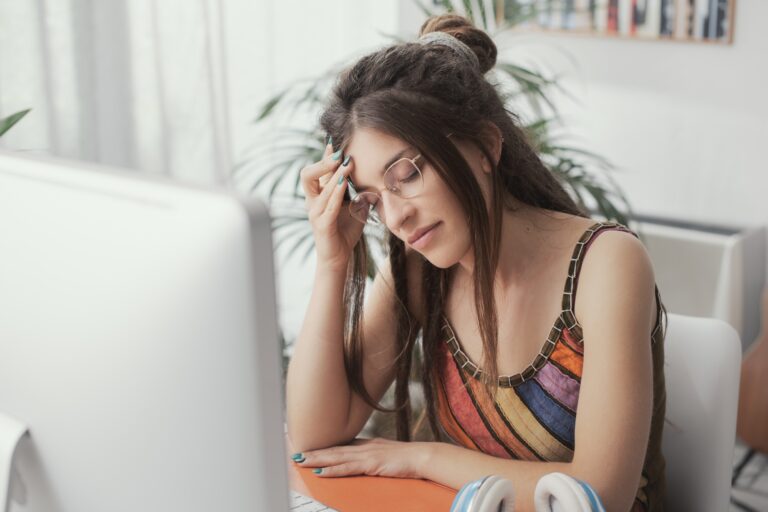 Tired young woman with headache