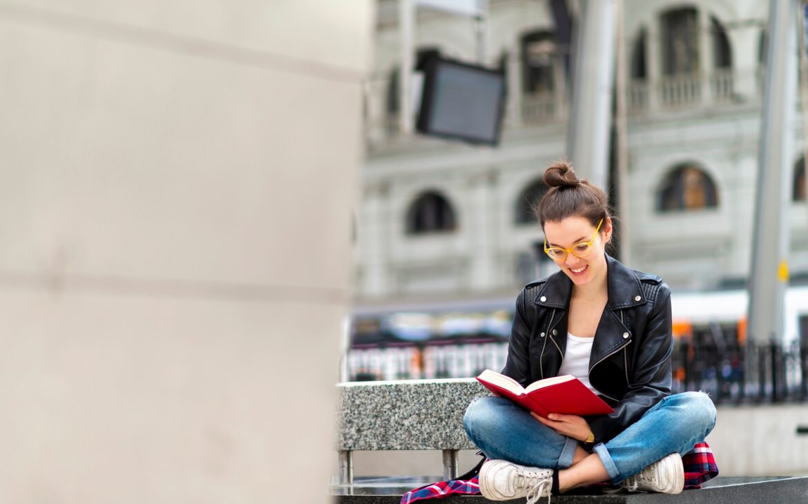 Woman reading book on bench