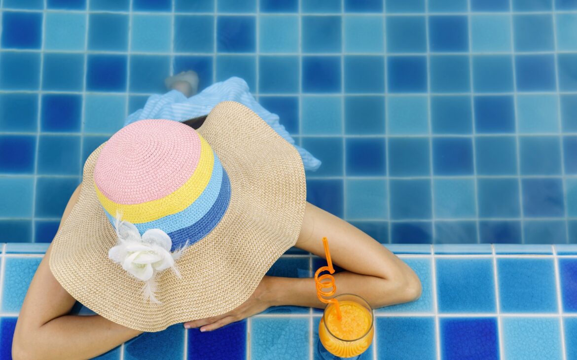 Woman relaxing at swimming pool, Summer vacation