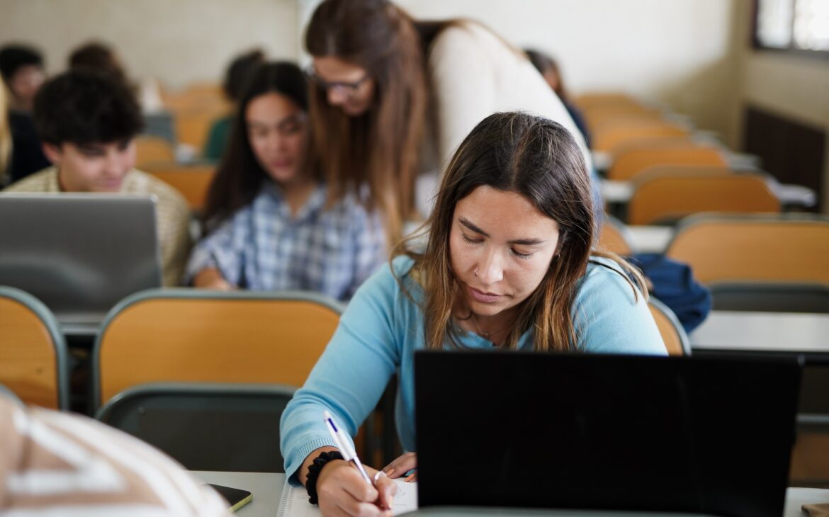 Young students learing inside university class room